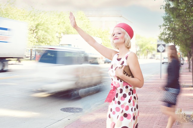 Woman wearing a polka dot midi dress with heels and a clutch for an evening event
