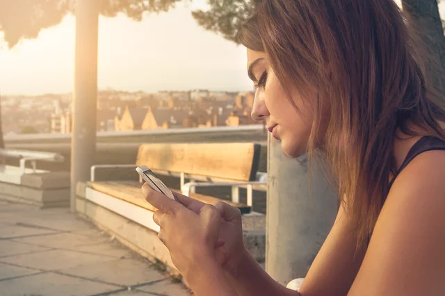 A young woman using her smartphone outdoors