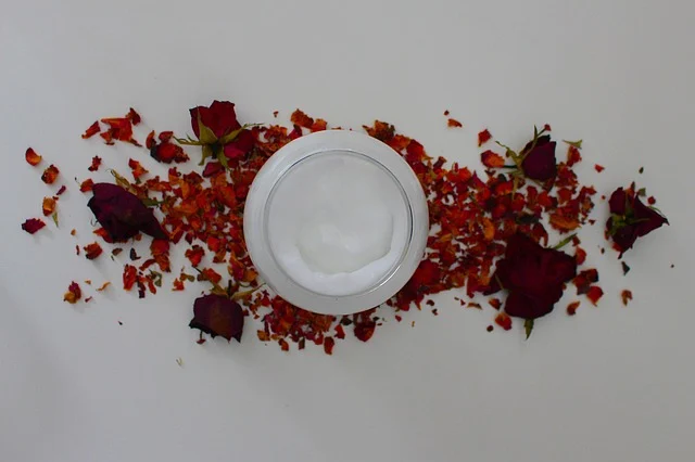 Best anti-aging cream: Open jar of face cream surrounded by dried rose petals