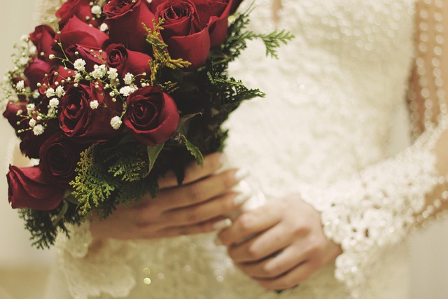 A bouquet featuring classic red Roses and delicate white Honeysuckle blossoms.