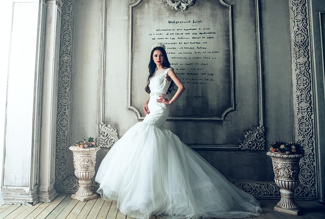 Bride in a classic long sleeve lace wedding dress, looking serene.