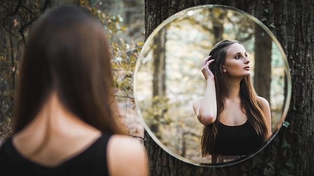 Bride looking in a mirror and appearing unsure about a simple, modern wedding dress, indicating a potential mistake in choice.