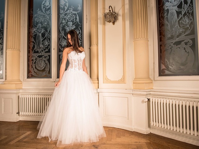 Bride trying on a corset wedding dress and smiling in a bridal boutique