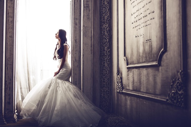 Bride wearing a drop waist wedding dress with elegant drop earrings and a delicate necklace