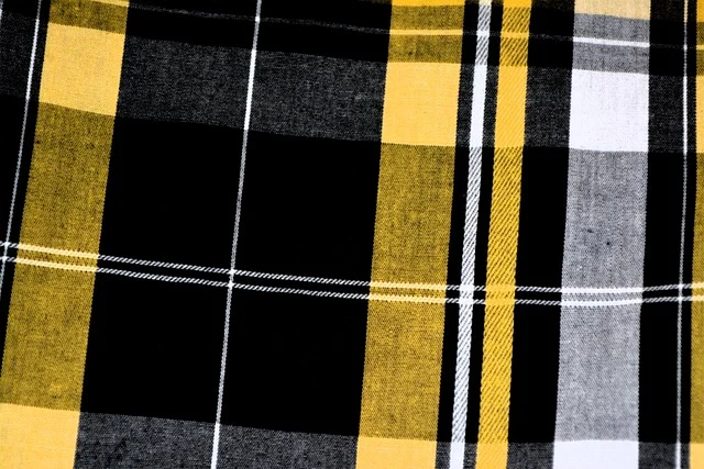 Yellow, black, and white plaid fabric pattern