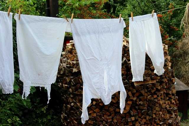 White vintage garments hanging on a clothesline outdoors