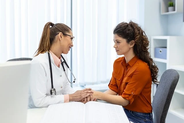 A female doctor or medical professional consulting with a patient