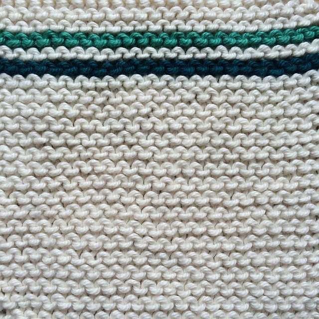 Close-up of textured knit fabric in a deep teal color.