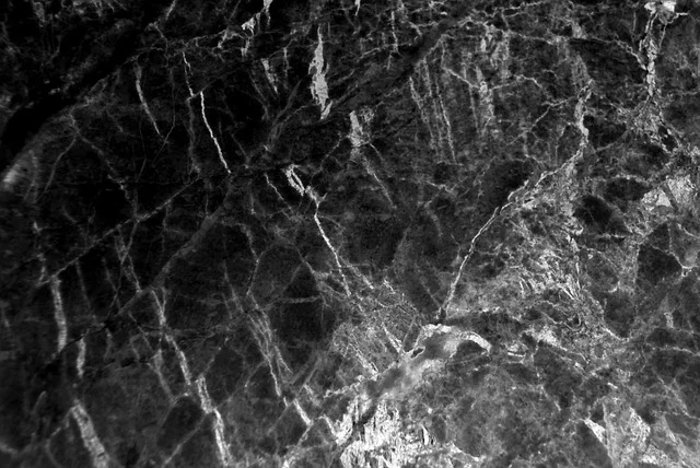 Close-up of dark marble or stone texture with white veins