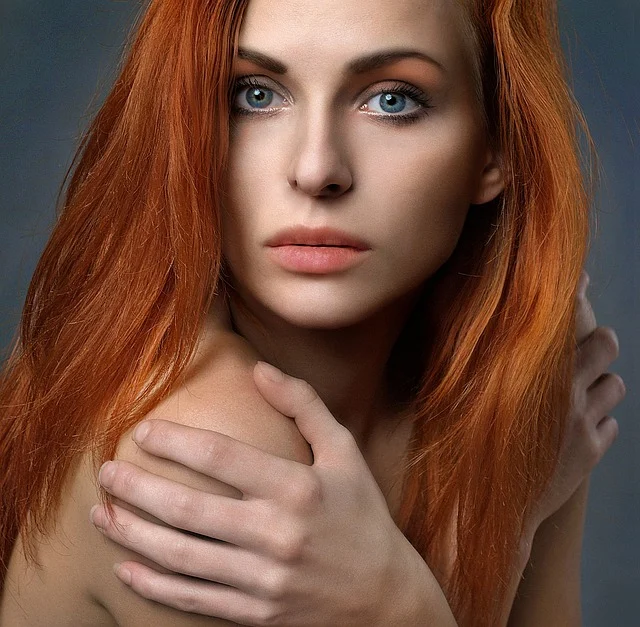 Close-up portrait of a woman with long red hair