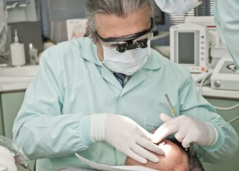 dermatologist examining patient's acne