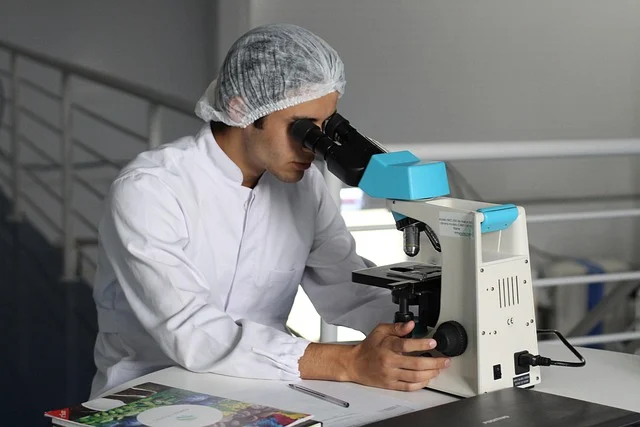 A researcher looking through a microscope in a laboratory