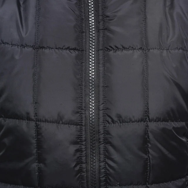 Close-up of zipper and stitching on a black quilted jacket
