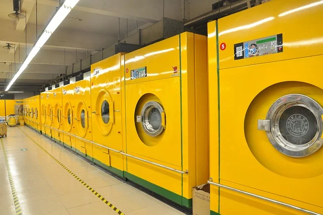A row of large yellow industrial washing machines