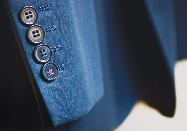 Close-up of buttons on a blue suit jacket sleeve