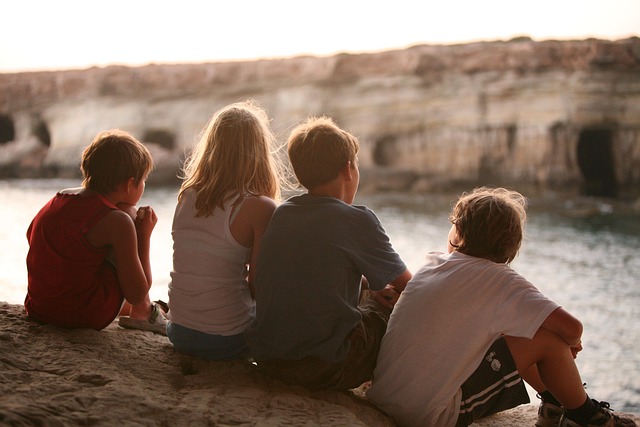 A group of children wearing stylish Zara Kids outfits showcasing current 2026 fashion trends like bright colors and relaxed silhouettes.