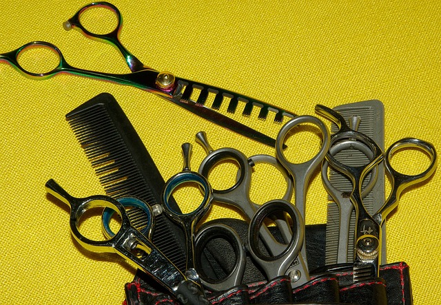 Hairdresser applying perm solution to hair wrapped in rods