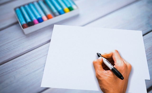 Hands sketching creative nickname ideas in a notebook with colorful pens and inspiration doodles. (unik nickname)