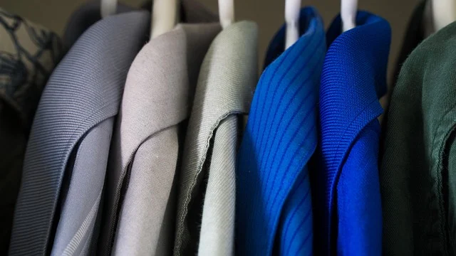 What to wear: Various collared shirts hanging on clothes hangers in a closet
