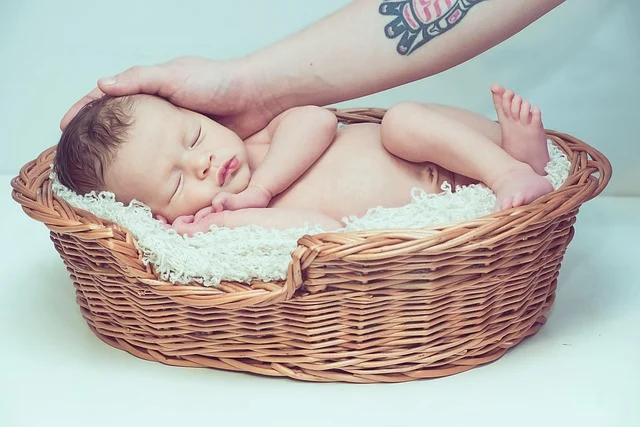 A sleeping newborn baby lying in a woven basket