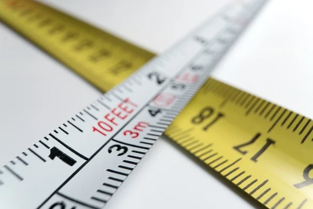 Two measuring tapes crossed over each other