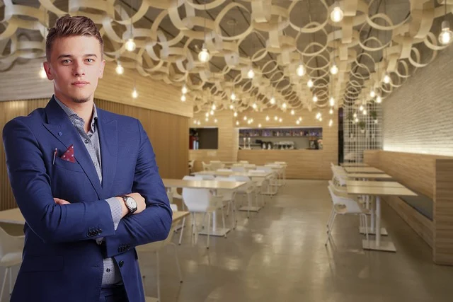 A young businessman standing inside a modern cafe or retail space