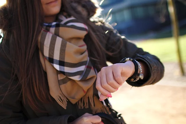 A woman wearing a iconic Burberry plaid scarf