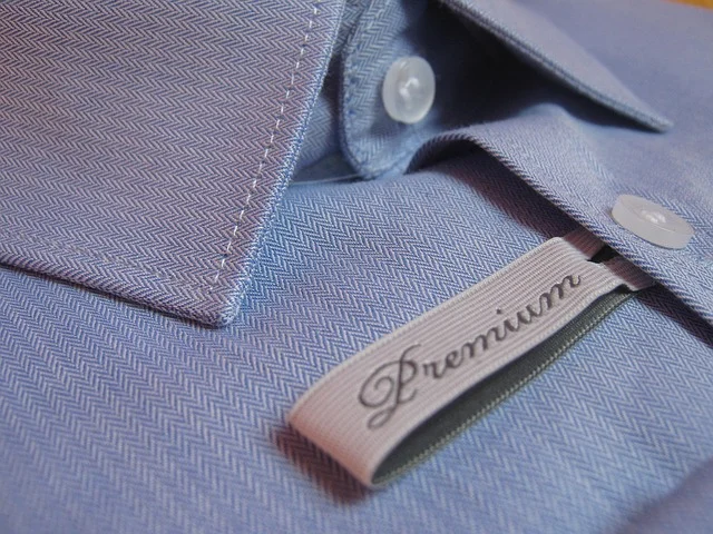 How to copyright a clothing brand name: A close-up of a blue shirt with a brand tag