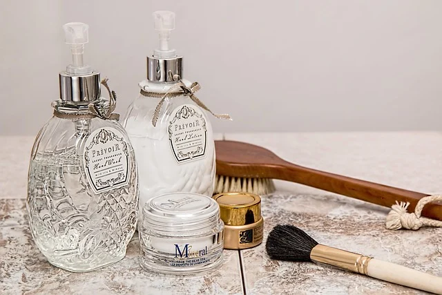 Skincare bottles, cream jars, and cosmetic accessories on a surface