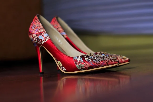 A pair of red embroidered high-heeled shoes