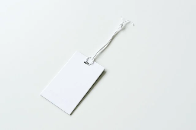 A blank white price tag with a string