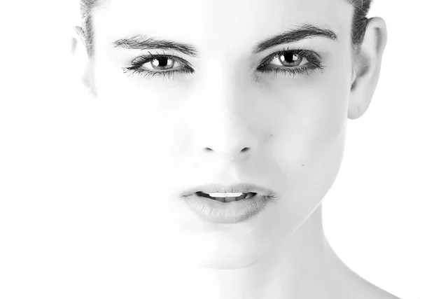 Close-up black and white portrait of a woman's face and neck