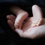 newborn baby clothes pile