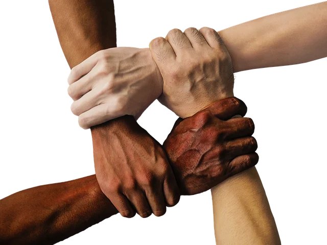Multiple hands holding wrists together symbolizing unity and support