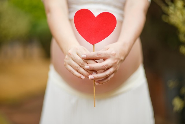 Pregnant woman browsing a rack of stylish maternity clothes