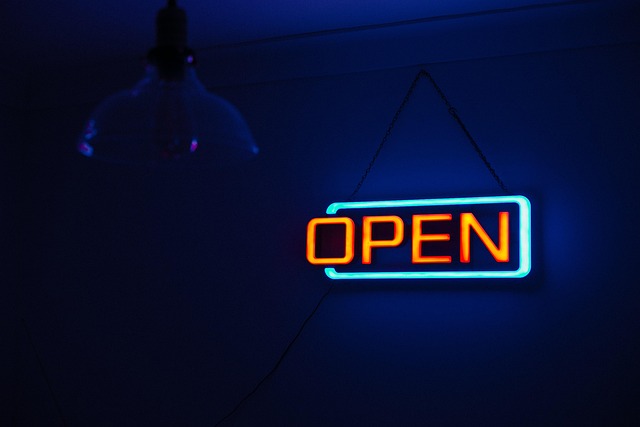 Retail storefront with 'Open' sign and a graphic overlay indicating financial flexibility