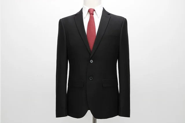 A black suit with a red tie on a mannequin