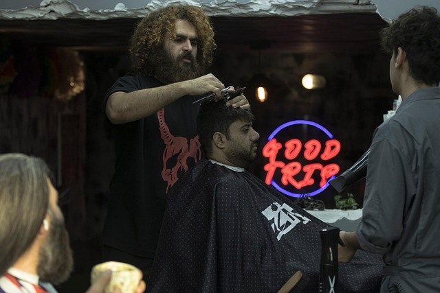 Stylist demonstrating how to scrunch hair with product for beach waves