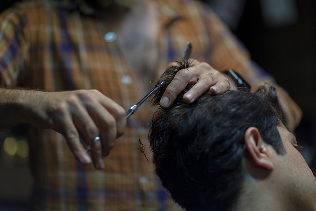 Stylist using scissors to create choppy layers on a wolf cut.