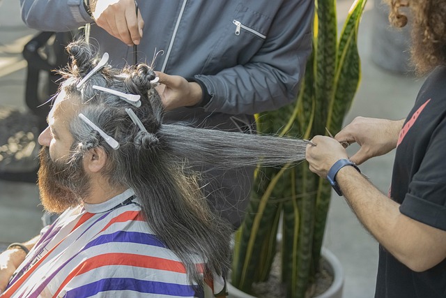 Stylist wrapping hair around large perm rods