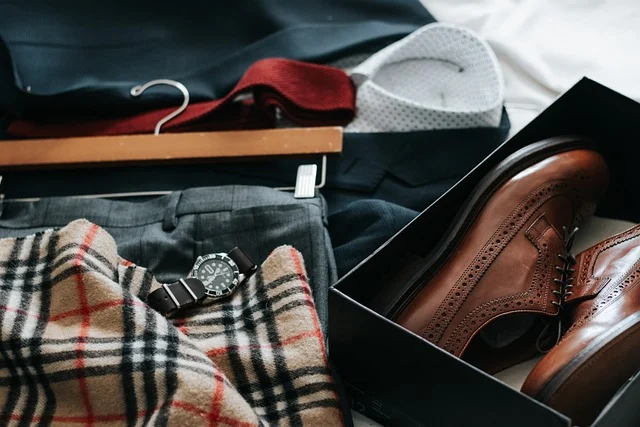 A flat lay of men's outfit including a Burberry check pattern scarf