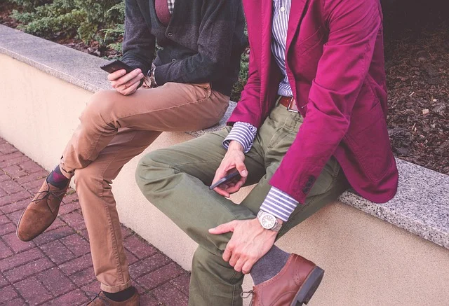 A man wearing a bright pink jacket with olive green pants