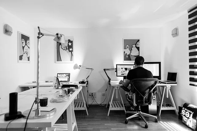 A person working at a computer desk in a modern office setup