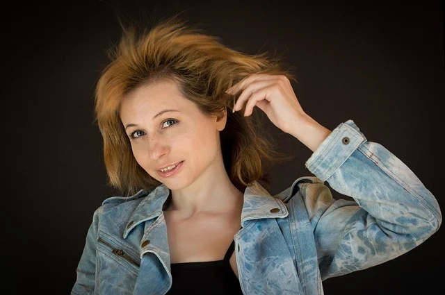 A woman wearing an acid-wash denim jacket