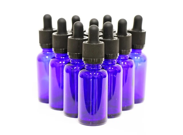 Multiple blue glass dropper bottles on a white background