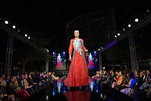 A fashion model walking down a runway at a fashion show