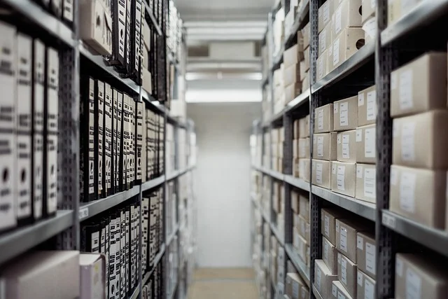 Shelves in a warehouse filled with binders and boxed inventory
