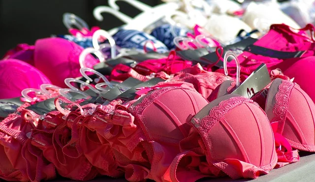 A display of pink bras and lingerie on hangers