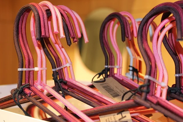 Pink clothes hangers on a rack in a retail store