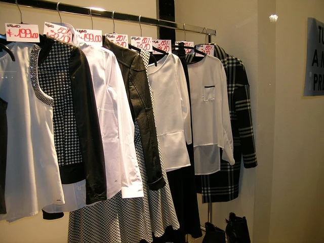 Clothes hanging on a clothing rack inside a boutique store